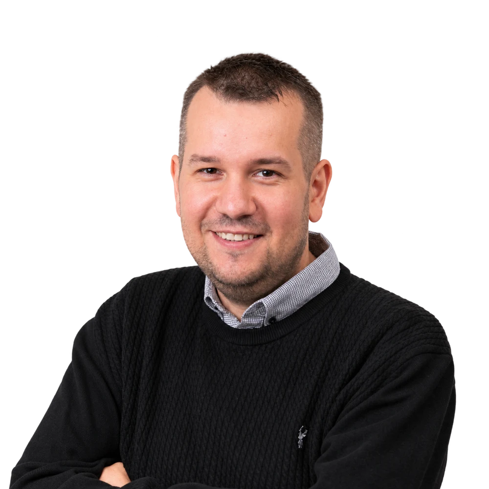 Dawid Zborowski, smiling with his arms folded